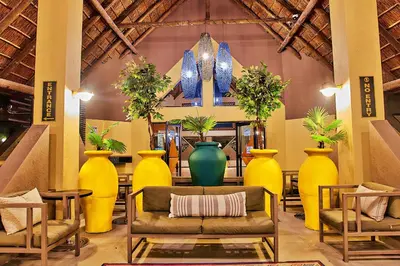 a living room with yellow vases and a couch at Sanbonani Hotel in Hazyview