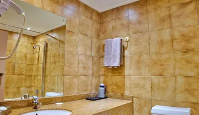a bathroom with a sink and a mirror at Sanbonani Hotel in Hazyview