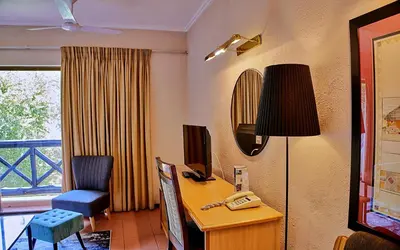 a room with a desk and a phone on a desk at Sanbonani Hotel in Hazyview