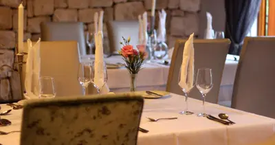 a table with wine glasses and flowers on it at La Villa Vita in Nelspruit