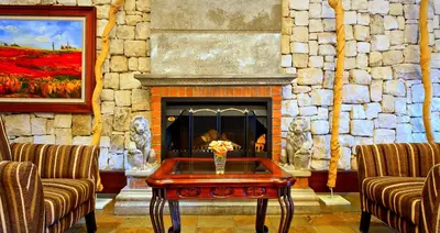 a living room with a fireplace and a coffee table at La Villa Vita in Nelspruit