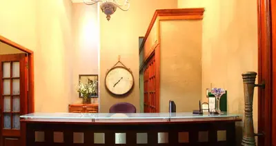 a clock on the wall of a room at La Villa Vita in Nelspruit