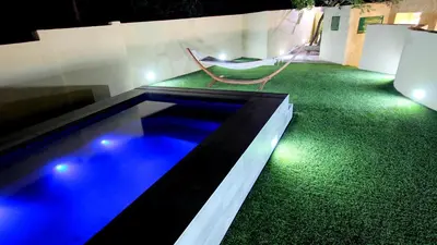 a swimming pool with a hammock in a house at La Villa Vita in Nelspruit