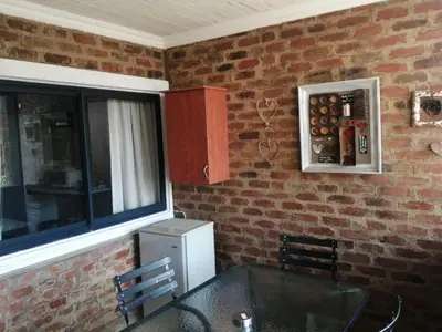 a kitchen with a table and a refrigerator at Zebrina Guest House in Nelspruit