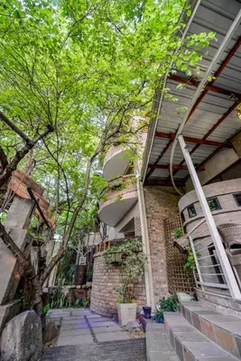 a brick house with stairs and a tree at Zebrina Guest House in Nelspruit