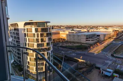 a view of a city with a tall building at Luxe Cityscape @ Waterfall Ellipse in Midrand