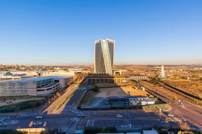 an aerial view of a city with a tall building at Luxe Cityscape @ Waterfall Ellipse in Midrand