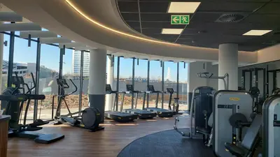 a gym with a row of treadmills and cardio machines at Luxe Cityscape @ Waterfall Ellipse in Midrand