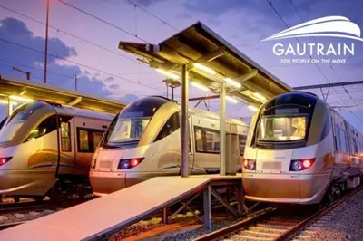 three trains are parked next to a train station at Luxe Cityscape @ Waterfall Ellipse in Midrand