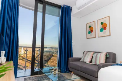 a living room with a couch and a glass table at Luxe Cityscape @ Waterfall Ellipse in Midrand
