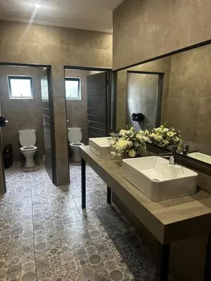 a bathroom with two sinks and two toilets at Mabalel in Crocodile Valley Estates