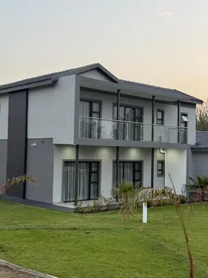 an exterior view of a house with a yard at Thandekile Garden Venue in Midrand