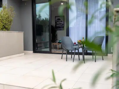 a patio with chairs and a table in a building at Luxurious Apartment, Ellipse, Waterfall, Midrand in Midrand