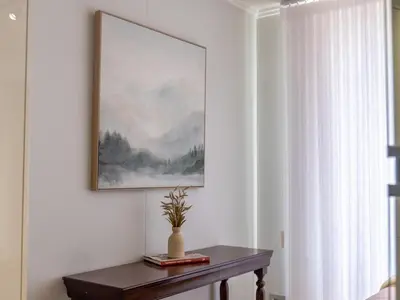 a table in a room with a painting on the wall at Luxurious Apartment, Ellipse, Waterfall, Midrand in Midrand