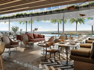 a restaurant with tables and chairs and a view of the ocean at Luxurious Apartment, Ellipse, Waterfall, Midrand in Midrand