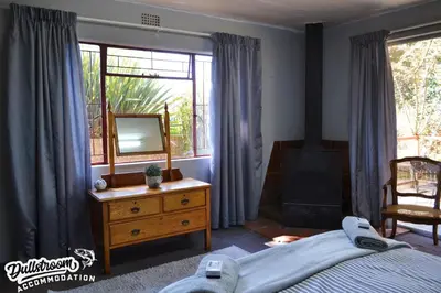 a bedroom with a bed and a mirror and a dresser at Sonata in Dullstroom