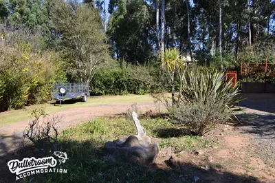 a garden with a statue of an elephant in the grass at Sonata in Dullstroom