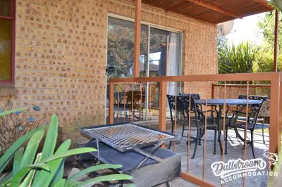 a patio with a table and chairs on a balcony at Sonata in Dullstroom