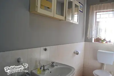 a bathroom with a sink and a toilet at Sonata in Dullstroom