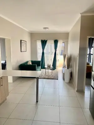 a living room with a couch and a table at Ladybug unit 3 (2) in Midrand