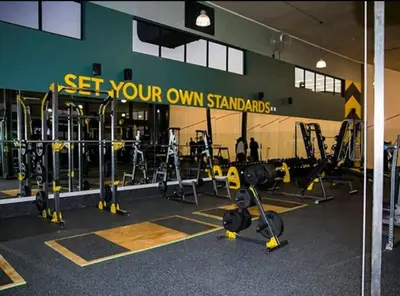 a gym with lots of equipment and people in the background at Vacation at the Blyde Riverwalk Estate in Pretoria