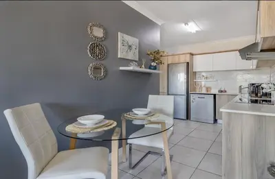 a kitchen with a table and chairs in a room at Vacation at the Blyde Riverwalk Estate in Pretoria