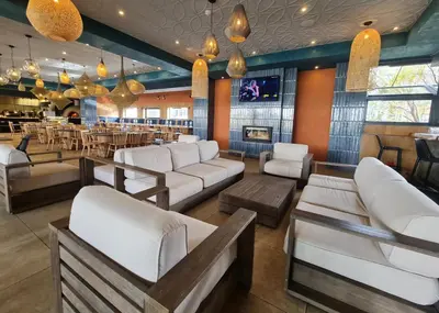 a restaurant with white couches and a bar at Vacation at the Blyde Riverwalk Estate in Pretoria