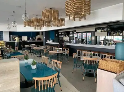 a restaurant with tables and chairs and a bar at Vacation at the Blyde Riverwalk Estate in Pretoria