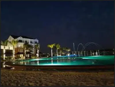 a swimming pool with a fountain at night at Vacation at the Blyde Riverwalk Estate in Pretoria