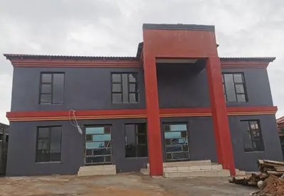 a house that is being painted blue and red at A home away from Home in Musina