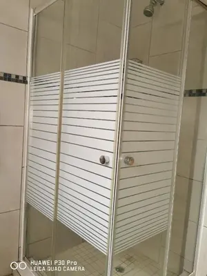 a shower with a glass door in a bathroom at A home away from Home in Musina