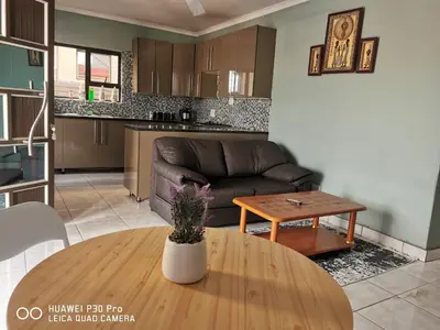 a living room with a couch and a table at A home away from Home in Musina