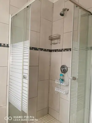 a shower in a bathroom with a glass door at A home away from Home in Musina