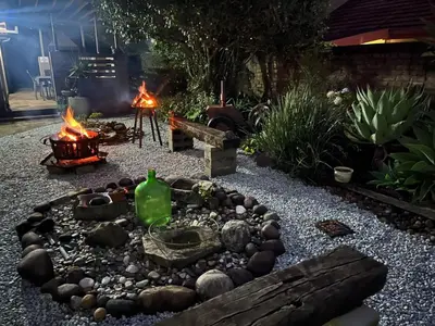 a fire pit in a backyard with a fire pit at Mi Casita in Graskop