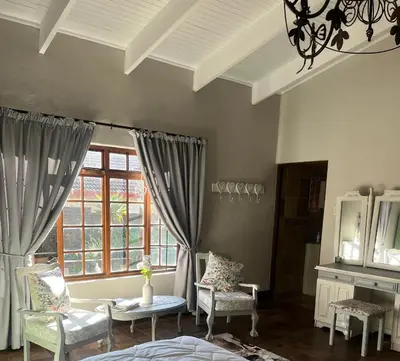 a room with two chairs and a window at Mi Casita in Graskop
