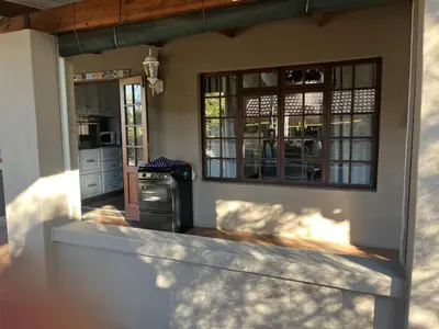 a kitchen with a stove in the middle of a house at Mi Casita in Graskop