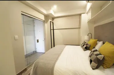 a bedroom with a large white bed with yellow pillows at Luxurious Resorts in Pretoria