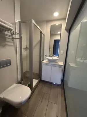 a bathroom with a white toilet and a sink at Luxurious Resorts in Pretoria