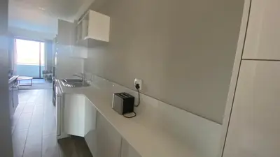 a white kitchen with a sink and a counter at Luxurious Resorts in Pretoria