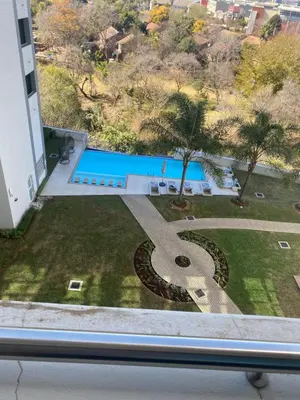 a view of a swimming pool from a window at Luxurious Resorts in Pretoria