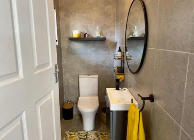 a bathroom with a toilet and a sink and a mirror at Lemon Ivy Guesthouse in Polokwane