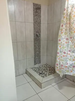 a shower in a bathroom with a shower curtain at Queen Light in Pretoria
