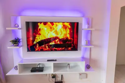 a tv with a fireplace in a living room at Havens corner in Sandton