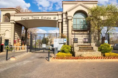 a building with an entrance to an apple tree estate at Havens corner in Sandton