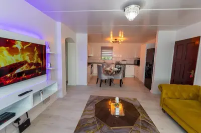 a living room with a couch and a tv at Havens corner in Sandton