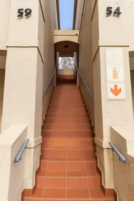 a hallway of a building with a long staircase at Havens corner in Sandton