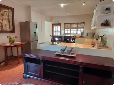 a kitchen with a large island in a room at Khalila's Equestrian Cottage in Midrand
