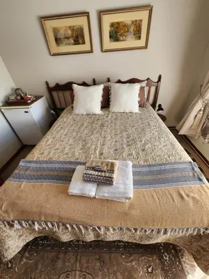 a bedroom with a bed with a remote control on it at Emani Guest House in Mokopane