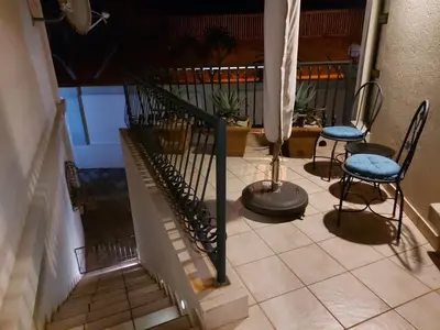 a stairway with two chairs and a table and a staircase at Bella's Place in Pretoria