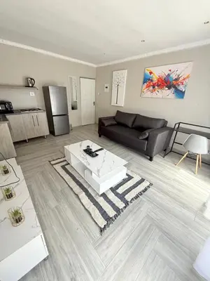 a living room with a couch and a coffee table at The Pool_deck apartment in Lebowakgomo
